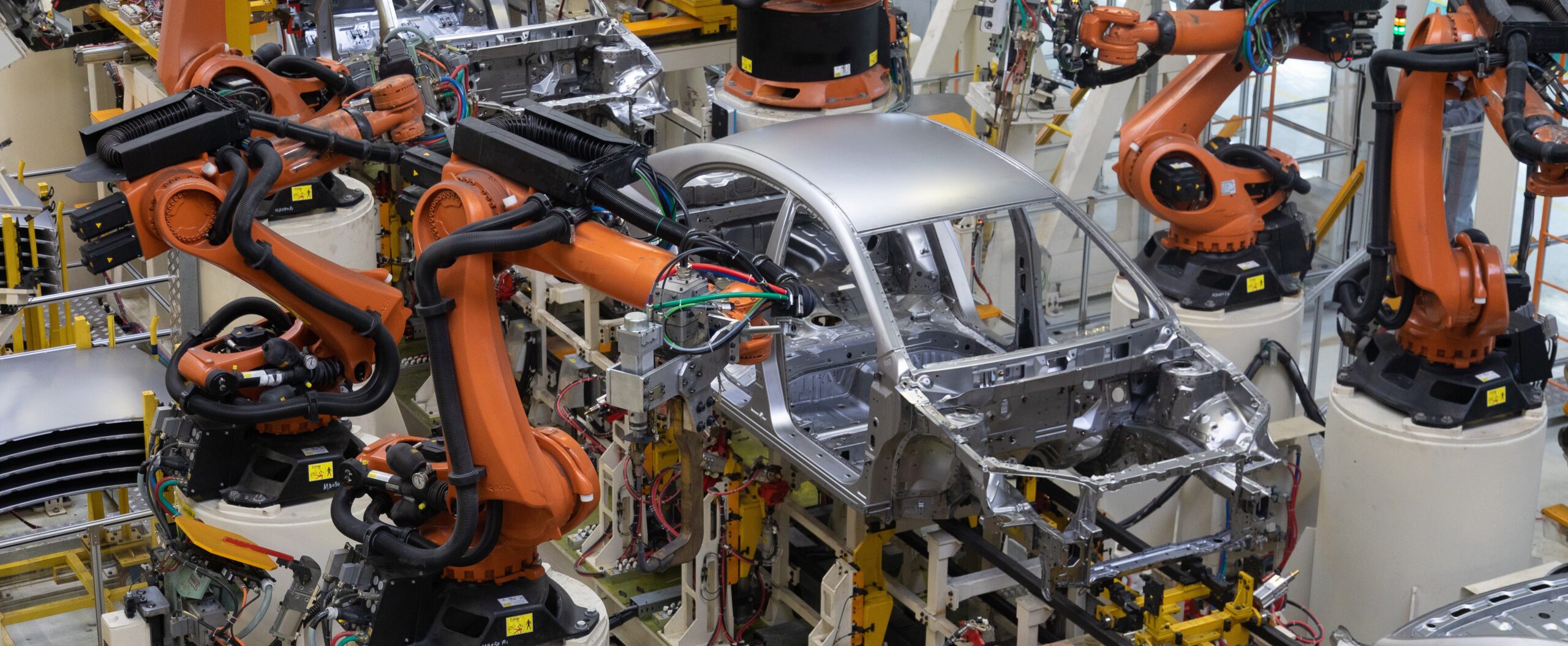 Modern technology of Assembly of cars. The plant of the automotive industry. Shop for the production and Assembly of machines top view. The process of welding parts of the car